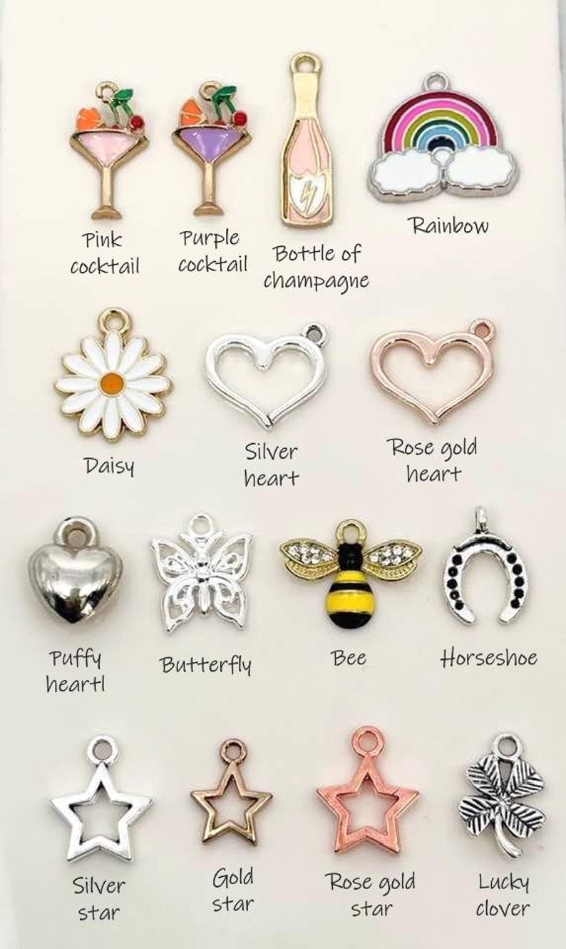 May include: Assortment of charm pendants for jewellery making.  Includes charms shaped like a daisy, heart, butterfly, bee, horseshoe, star, and clover.  Charms are made of silver, rose gold, and gold metal.