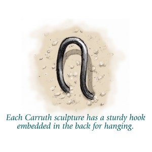 May include: A close-up of a sturdy metal hook, designed for hanging, embedded in the back of a sculpture. The hook is made of a dark metal and is shaped like a U.