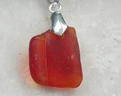 Dainty rare red shade of naturally tumbled sea glass, sea stone pendant with pinch bail.