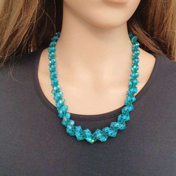 This crystal and seed bead necklace has been hand woven in a spiral design