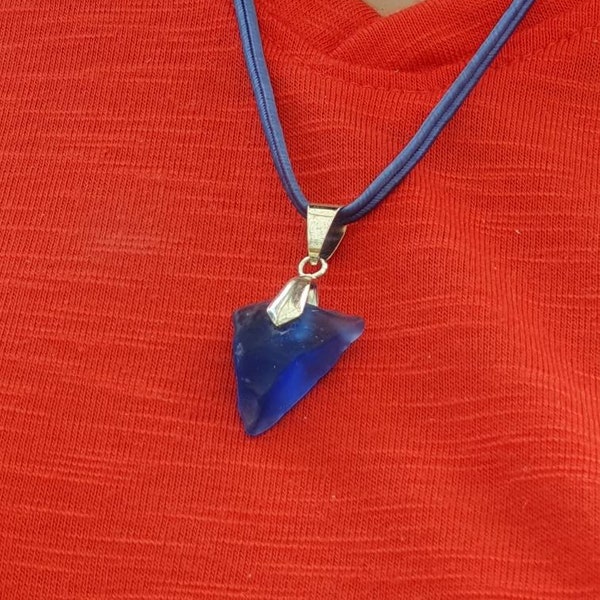 Rare blue naturally tumbled and shaped by the sea a dainty piece of glass, top drilled with pinch bail and cord pendant.