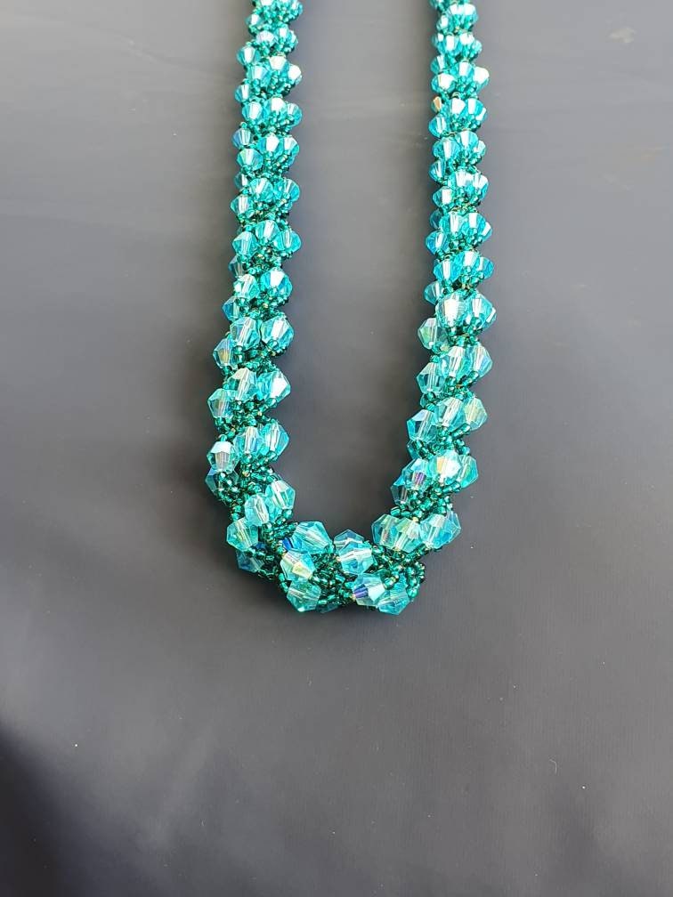 This crystal and seed bead necklace has been hand woven in a Etsy