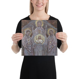 May include: A painting depicting a religious scene with three figures. The central figure is a woman with a halo, holding a child in her arms. The child also has a halo. The figures are surrounded by a golden glow.