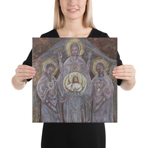 May include: A painting depicting a religious scene with three figures. The central figure is a man with a halo, surrounded by two women with halos. The figures are painted in a soft, ethereal style with muted colors.