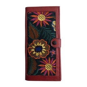 May include: A red leather wallet with a floral embroidered design. The embroidery features colourful flowers and leaves on a dark green background.