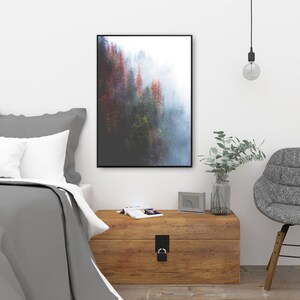 May include: A framed photograph of a misty forest with tall trees in shades of green, brown, and red. The trees are partially obscured by fog, creating a dreamy and ethereal atmosphere.