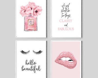 May include: Set of four pink and white printable wall art prints with quotes about being classy and fabulous, eyelashes, and lips. The prints are perfect for a bedroom or bathroom.