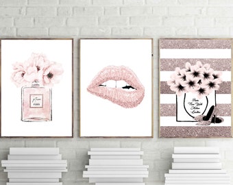 May include: Three pink and white framed prints with a glitter background. The first print features a pink perfume bottle with flowers. The second print features a pink glitter lip. The third print features a pink perfume bottle with flowers and the text "Paris New York Milan London".