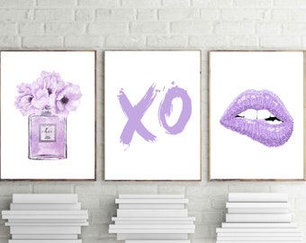 May include: Three framed prints with a purple theme. The first print features a purple perfume bottle with a bouquet of purple flowers. The second print features the letters XO in purple. The third print features a purple glitter lip.