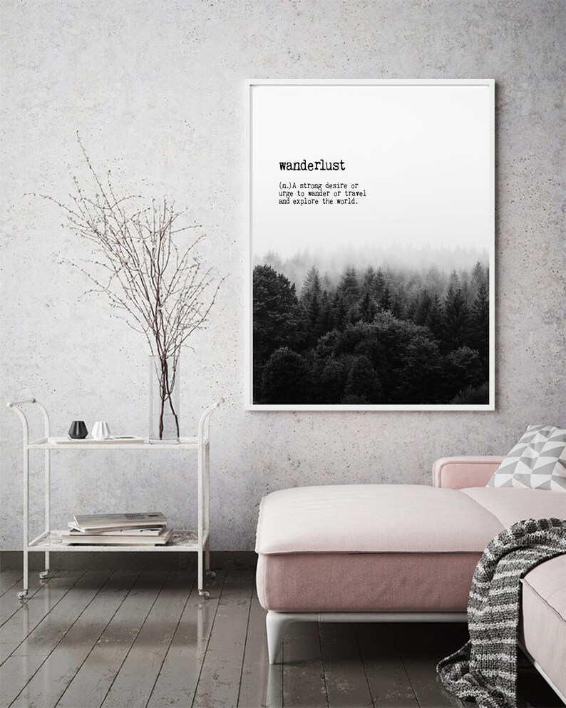 May include: A black and white print with the word "wanderlust" defined as a strong desire to travel and explore the world. The print features a foggy forest scene.