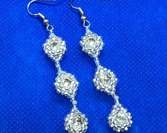 Dangle earrings with clear crystals and white beads