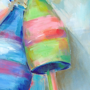 May include: Three colorful, striped buoys, painted in shades of blue, green, pink, and white. The buoys are stacked on top of each other, with the blue buoy on the bottom, the green buoy in the middle, and the pink buoy on top.