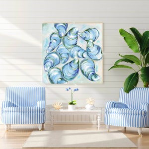 May include: A painting of blue and green oysters on a white background. The painting is framed and hanging on a white wall.