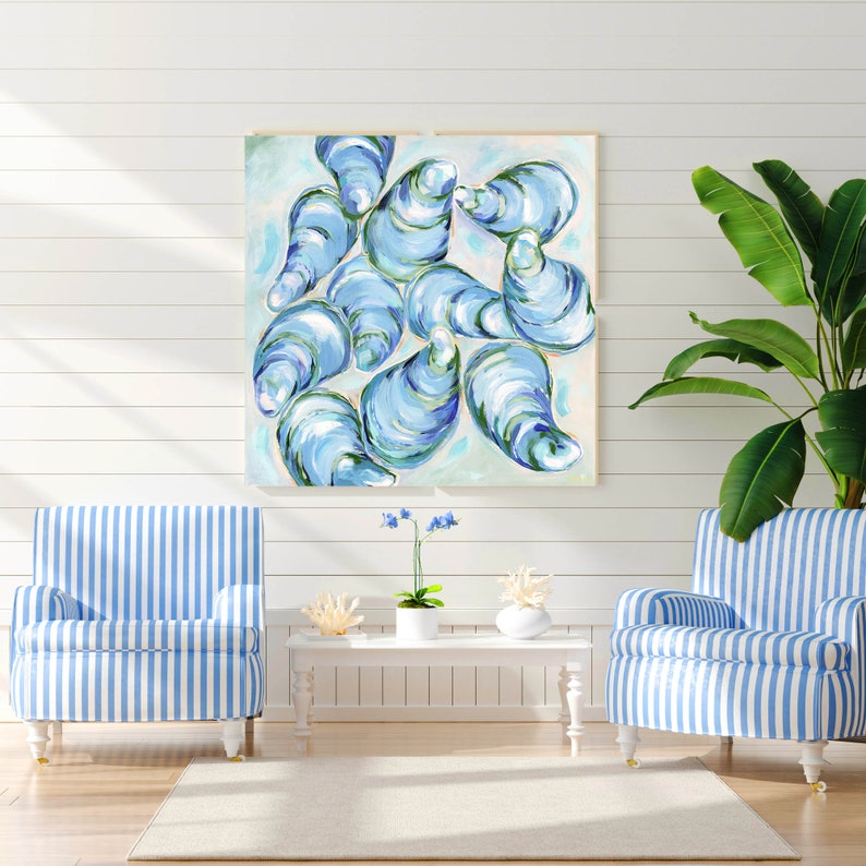 May include: A painting of blue and green oysters on a white background. The painting is framed and hanging on a white wall.