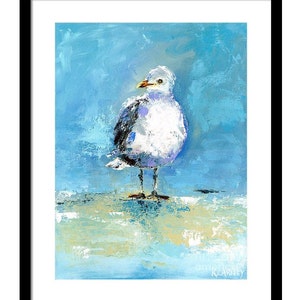 May include: An oil painting of a seagull with white, gray, and black feathers, standing on a light-colored surface. The background is a textured blue, and the artwork is framed in black. The seagull has a yellow beak and is looking to the side.