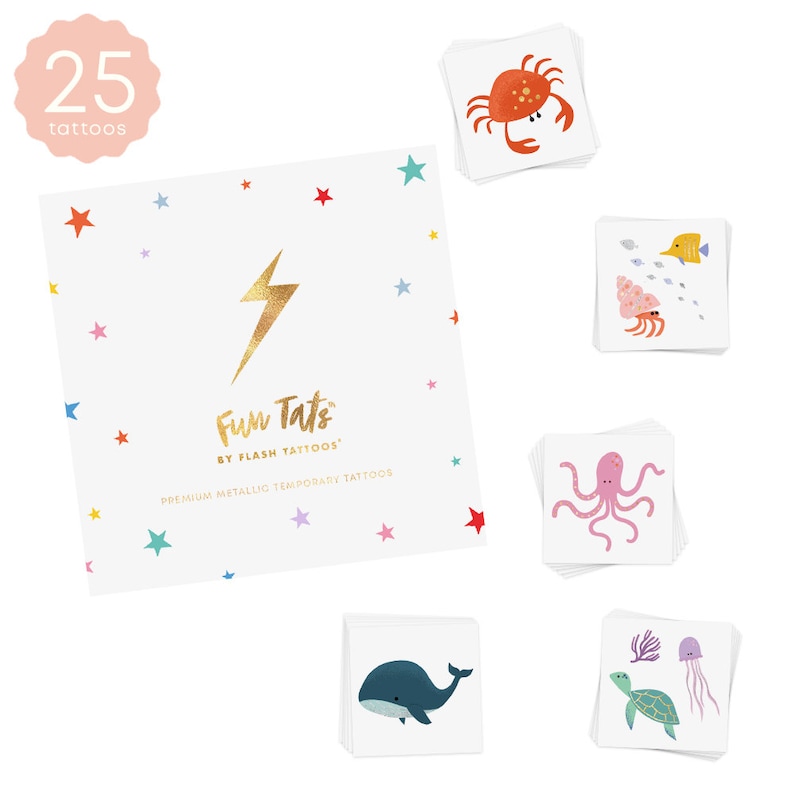 May include: A set of 25 temporary tattoos featuring a variety of sea creatures, including a crab, a fish, an octopus, a whale, a turtle, and a jellyfish. The tattoos are metallic and come in a variety of colors, including pink, blue, orange, and green. The tattoos are packaged in a white square box with a gold lightning bolt and the text "Fun Tats by Flash Tattoos" and "Premium Metallic Temporary Tattoos".