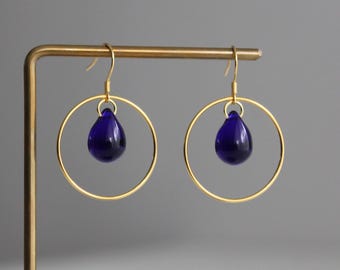 Gold plated over silver hoop earrings with cobalt blue glass teardrops
