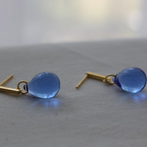 Sapphire blue glass teardrop earrings with gold plated over silver bar push backs