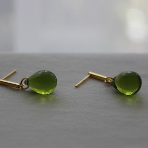 Peridot glass teardrop earrings with gold plated over silver bar push backs