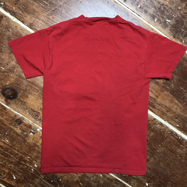 May include: A plain red t-shirt with a crew neck.