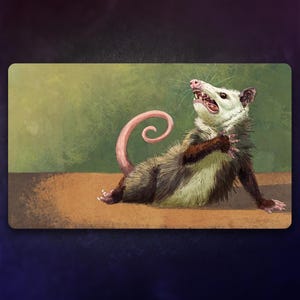 May include: A white and brown opossum with a pink curled tail is sitting on a brown surface with a green background. The opossum has its mouth open and its teeth are visible.