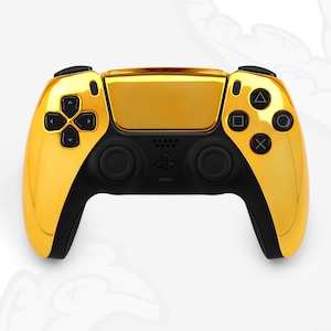 May include: A gold-coloured PlayStation 5 controller with black buttons and a black faceplate. The controller has a textured surface and a glossy finish.