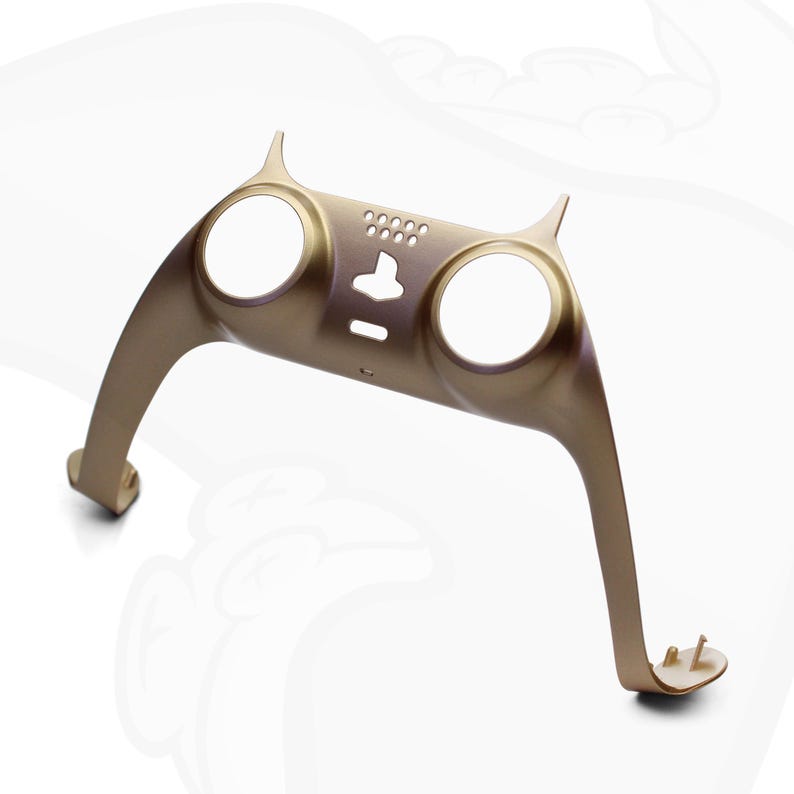 Op de afbeelding: Een gouden plastic controller-behuizing met twee ronde uitsparingen en een kleine rechthoekige uitsparing. De behuizing heeft aan elke kant een kattenoor-ontwerp.