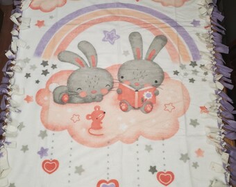 Reading bunnies themed knotted fleece blanket