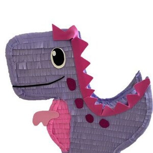 May include: Purple and pink dinosaur piñata with a textured surface. The dinosaur has a pink crest, pink spots, and a pink tail.