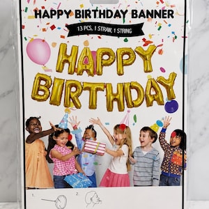 May include: A Happy Birthday banner kit in a plastic package containing 13 gold foil letter balloons, one straw, and one string. The packaging features text reading HAPPY BIRTHDAY BANNER, 13 PCS, 1 STRAW, 1 STRING, and an image of children.