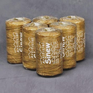 May include: Six spools of artificial sinew thread, wrapped in clear plastic. The thread is a light brown color, and the label reads "Artificial Sinew". The text on the label also mentions that the thread is waxed and can be split into thinner strands.