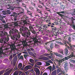 May include: Close-up of decorative tiles with a repeating geometric pattern. The tiles feature a rich palette of purple hues, accented with gold-coloured lines. The design is intricate and symmetrical, creating a visually appealing surface.