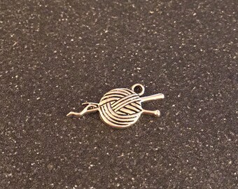 Ball of yarn with knitting needles charm