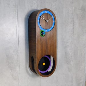 Modern cuckoo clock, multicolored, round big pendulum