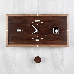 May include: A wooden wall clock with a pendulum and a white face with black Roman numeral markings. The clock has a dark wood frame and a small window on the right side.