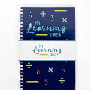 May include: A blue spiral notebook with the words "My Learning Ledger" on the cover. The cover is decorated with math symbols, numbers, and pencils.
