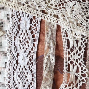 May include: Assortment of white lace trims with different patterns and textures. The lace trims are arranged on a brown surface.