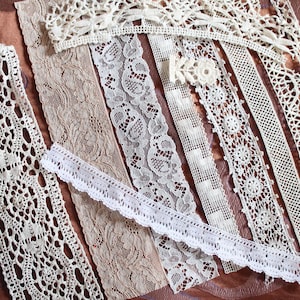 May include: Assortment of white lace trims with various patterns and textures. The lace trims are arranged in rows on a brown fabric background.