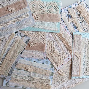 May include: Assortment of white and cream lace trim, some with a delicate floral pattern, arranged on a white surface.