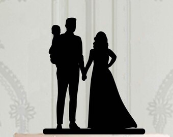 Wedding cake topper with groom holdind a baby