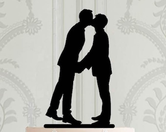 Könnte beinhalten: Schwarze Silhouette von zwei Personen, die sich küssen, ein Hochzeitstortenaufsatz.