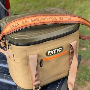 Leather sling shown as its intended use.