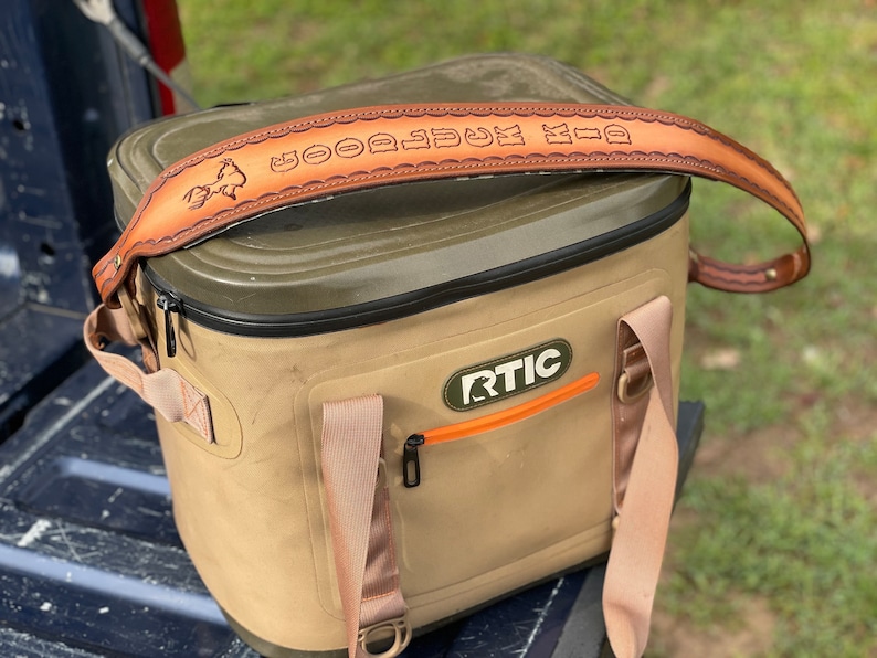 Leather sling shown as its intended use.