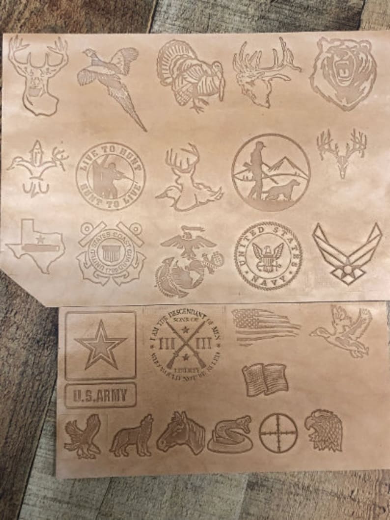 May include: A brown leather sheet with various designs and logos, including a turkey, a deer, a bear, a pheasant, a star, a cross, a duck, a snake, a target, and an eagle. The text "LIVE TO HUNT HUNT TO LIVE" is also visible.