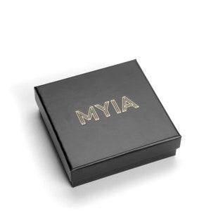 May include: A black square box with the word "MYIA" printed in gold lettering.