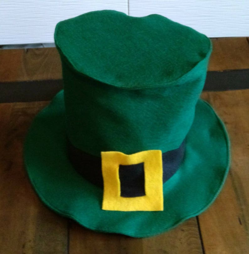 May include: A green felt leprechaun hat with a black band and a yellow buckle.