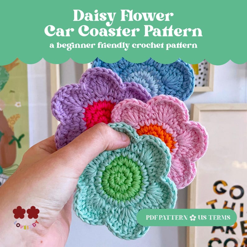 May include: A collection of handmade crochet daisy flower car coasters in various colors, including blue, purple, pink, and green. The coasters have a textured appearance and are held in a hand. The image includes text that reads "Daisy Flower Car Coaster Pattern".