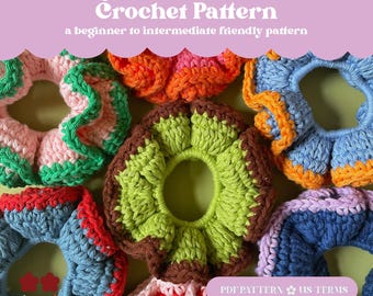 May include: A collection of colorful, handmade crochet scrunchies. The scrunchies feature a ruffled design in various colors, including pink, green, orange, blue, and red. The image also includes text that reads "Fritly Ruffle Scrunchie Crochet Pattern".