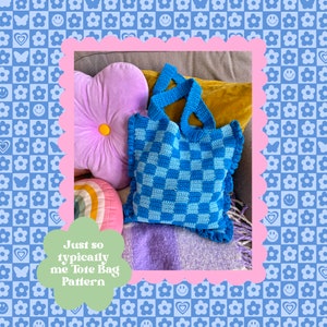 May include: A blue and light blue checkered crochet tote bag with frilled edges and handles. The bag is on a sofa with a purple flower cushion, a rainbow cushion, and a purple blanket. Text on the image reads "Just so typically me Tote Bag Pattern."