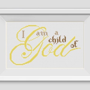 May include: A framed cross-stitch design with the text "I am a child of God" in yellow and brown thread on a white background.